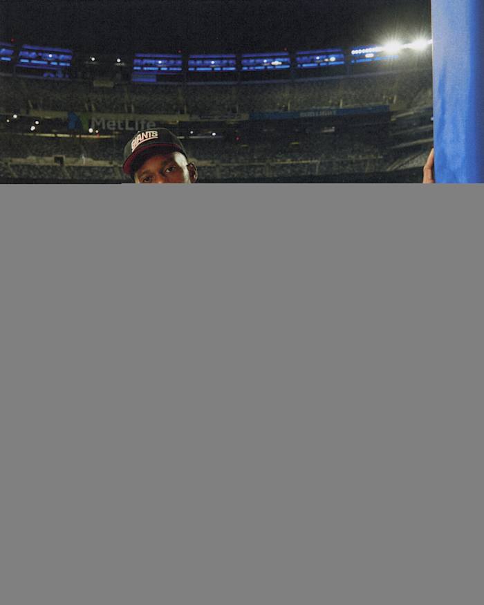 Victor Crus models New York Giants apparel.